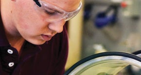 Person working with glasses in a workshop